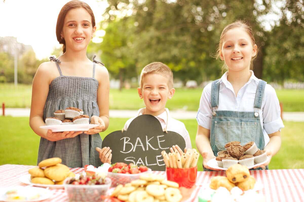 Kids selling goods at a bake sale